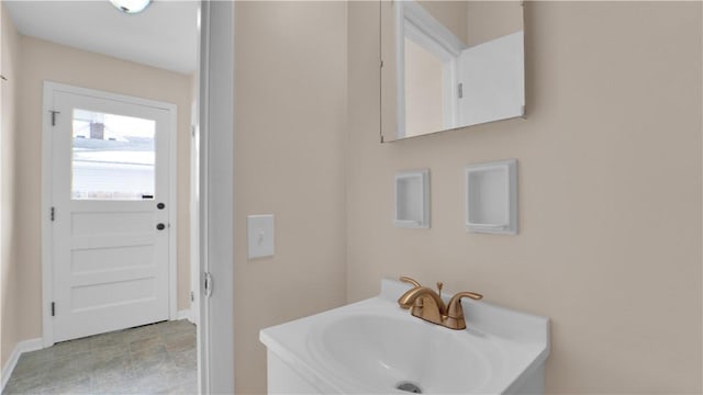 bathroom with baseboards and a sink