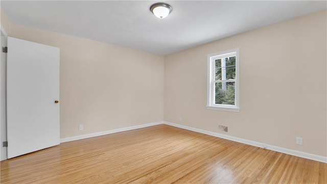 unfurnished room featuring light wood-type flooring and baseboards