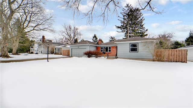 ranch-style home featuring a garage, a chimney, and fence