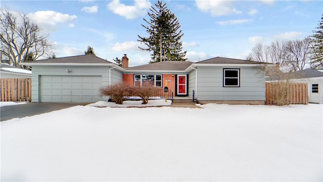 ranch-style home featuring an attached garage, a chimney, driveway, and fence