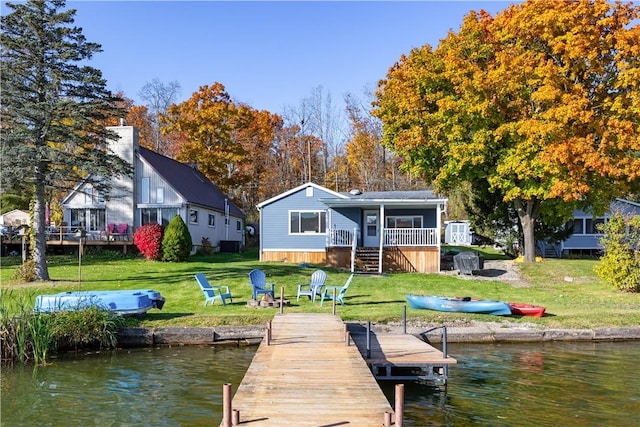 view of dock featuring a yard and a water view