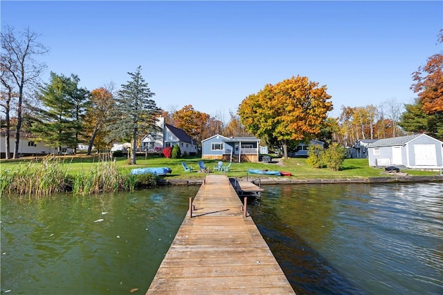 dock area featuring a yard and a water view