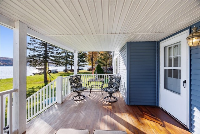 deck featuring a porch and a water view