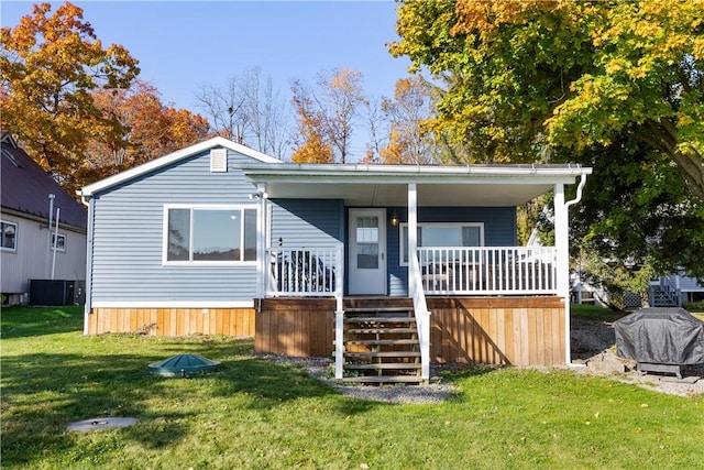 view of front of property with stairs, a front yard, and a porch