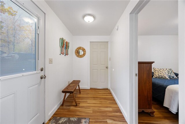 entryway with light wood-type flooring and baseboards