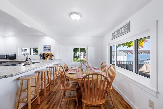 dining space with wood finished floors