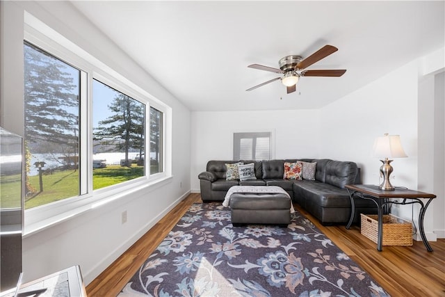 living area featuring a ceiling fan, wood finished floors, and baseboards