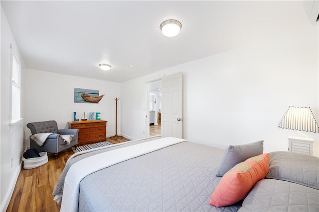 bedroom featuring baseboards and wood finished floors