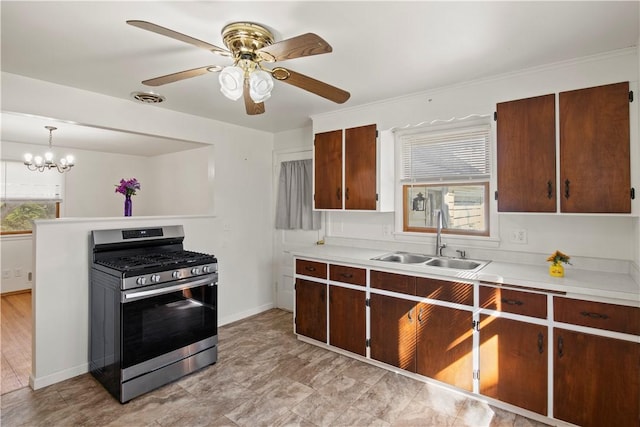 kitchen featuring a healthy amount of sunlight, visible vents, stainless steel range with gas cooktop, a sink, and light countertops