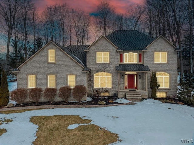 traditional-style house featuring a shingled roof