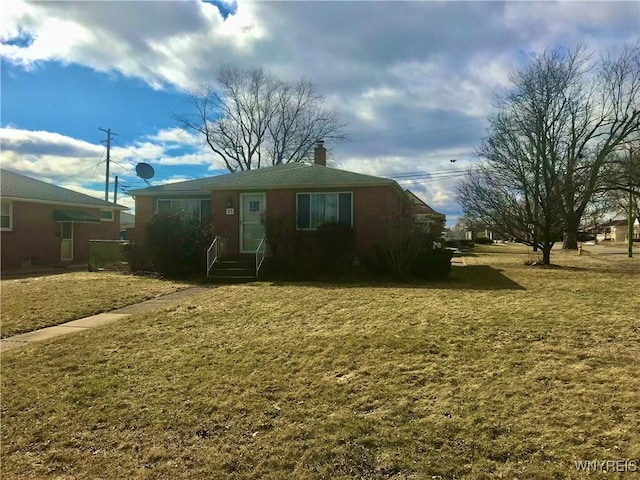 view of front of house with a front lawn and a chimney