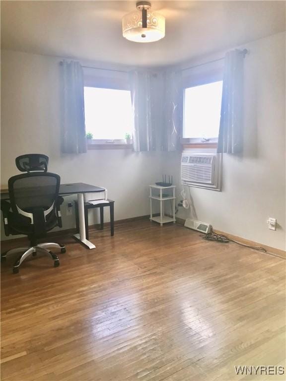 office area with hardwood / wood-style floors, cooling unit, and visible vents