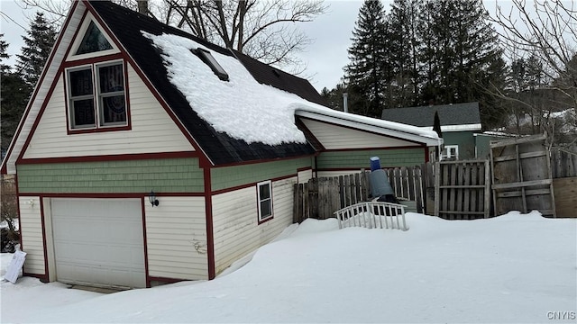 view of snowy exterior with fence