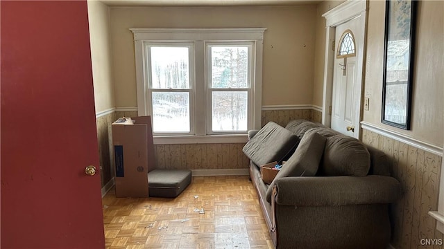 sitting room with a wainscoted wall and wooden walls