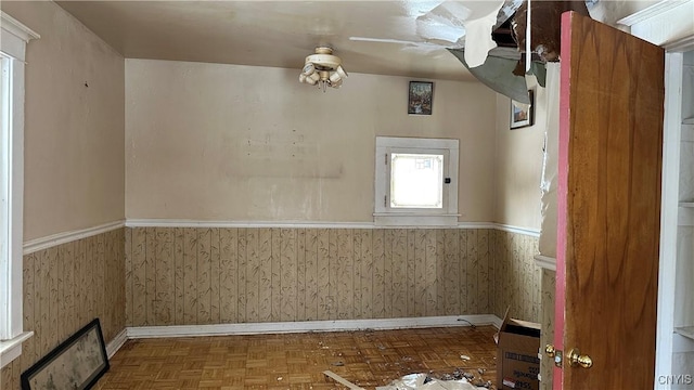 unfurnished room featuring wainscoting and baseboards