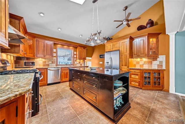 kitchen featuring a kitchen island, vaulted ceiling, light stone counters, stainless steel appliances, and open shelves