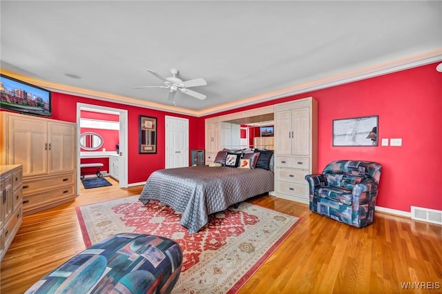 bedroom with visible vents, baseboards, light wood-style floors, and ceiling fan