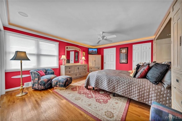 bedroom featuring visible vents, wood finished floors, and a ceiling fan