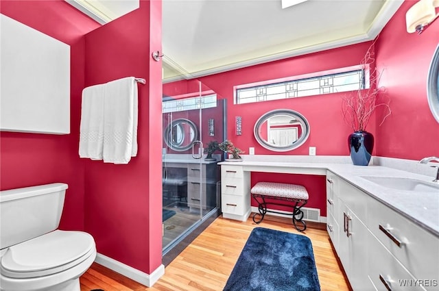 full bath with baseboards, toilet, wood finished floors, and vanity