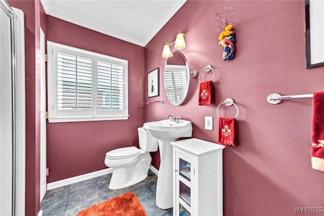 bathroom with baseboards, toilet, and ornamental molding