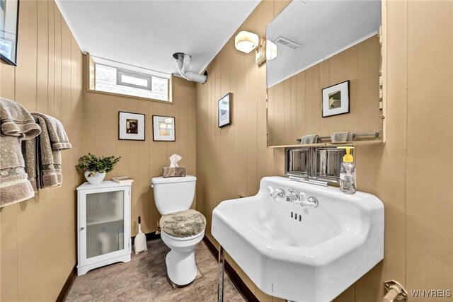 bathroom featuring a sink, visible vents, and toilet