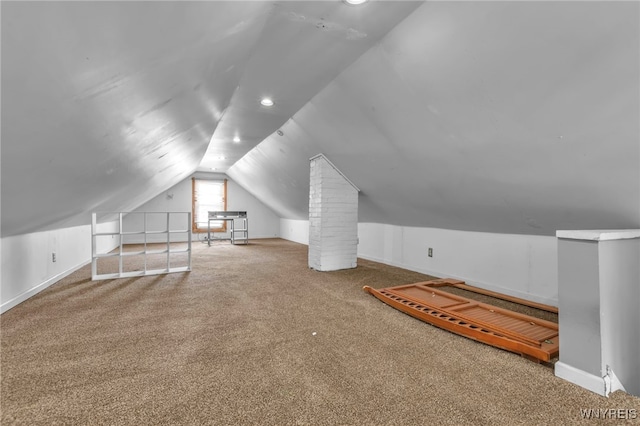 additional living space featuring carpet and vaulted ceiling