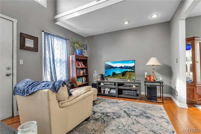 living area with recessed lighting, baseboards, and wood finished floors