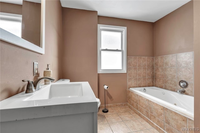 full bath featuring tile patterned flooring, toilet, vanity, and a garden tub