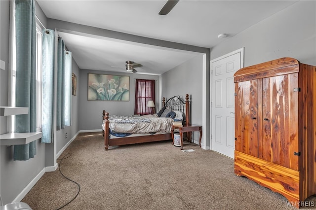 carpeted bedroom featuring multiple windows, a ceiling fan, and baseboards