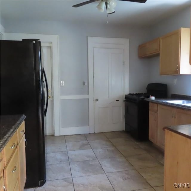 kitchen featuring a ceiling fan, black appliances, dark countertops, and light brown cabinets