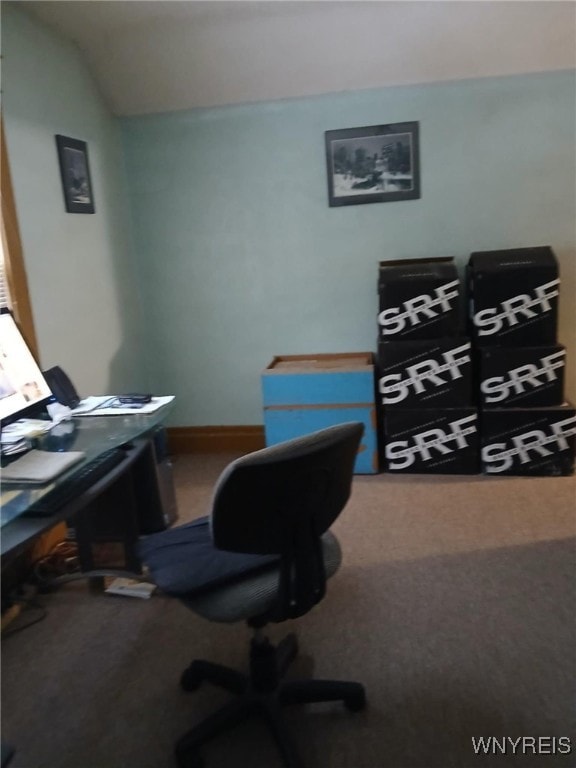 carpeted office with lofted ceiling