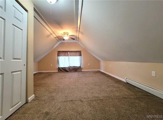 additional living space with a ceiling fan, carpet floors, baseboards, baseboard heating, and vaulted ceiling