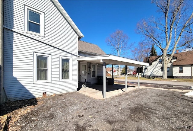 exterior space with roof with shingles