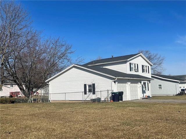 view of side of home with fence, a lawn, and driveway