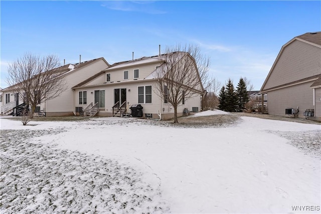 snow covered house with cooling unit