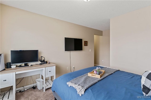 bedroom featuring carpet floors and a textured ceiling