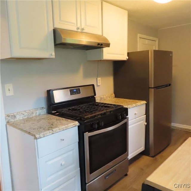 kitchen featuring white cabinetry, light wood finished floors, under cabinet range hood, and stainless steel appliances