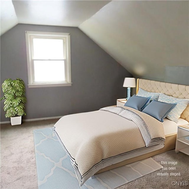 bedroom featuring baseboards, lofted ceiling, and carpet