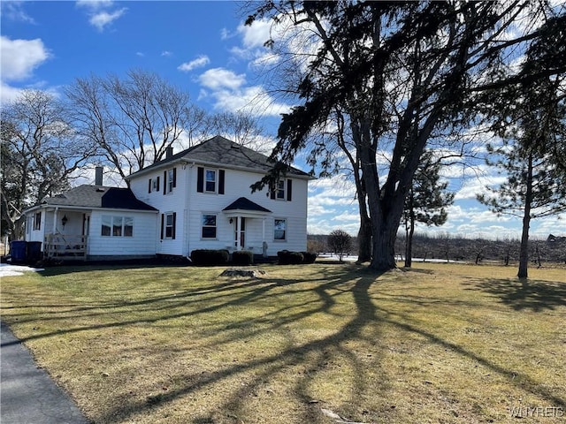 view of front of home featuring a chimney and a front yard