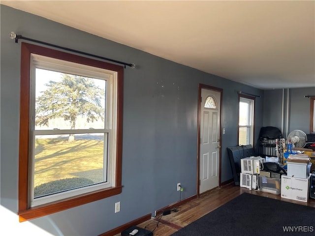 interior space with wood finished floors and baseboards