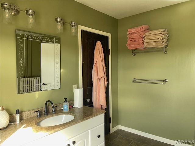 bathroom featuring baseboards, vanity, and tile patterned flooring