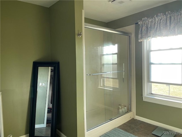 full bathroom featuring tile patterned flooring, visible vents, a stall shower, and baseboards