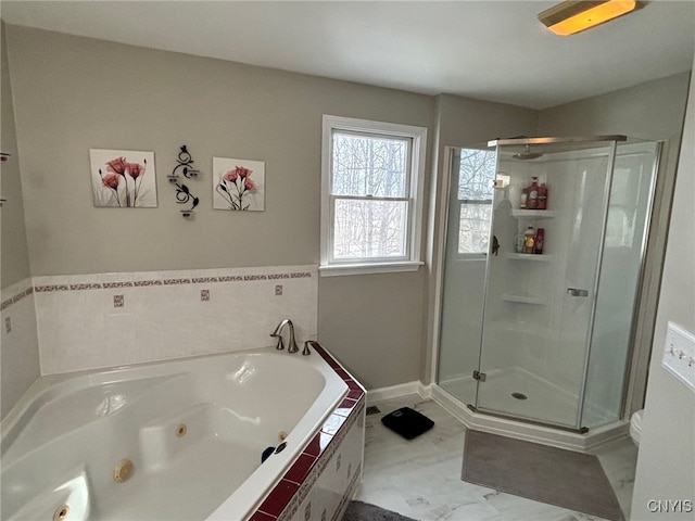 full bathroom with toilet, marble finish floor, a jetted tub, a shower stall, and baseboards