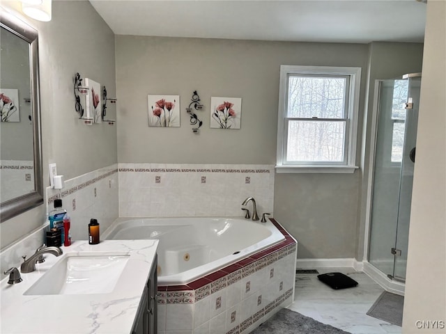 bathroom with marble finish floor, vanity, a shower stall, and a whirlpool tub