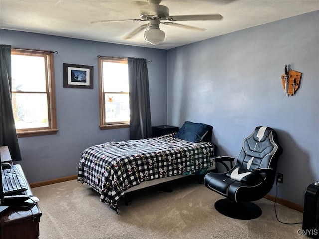 bedroom with baseboards, multiple windows, carpet floors, and a ceiling fan