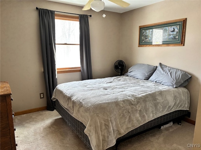 bedroom featuring ceiling fan, baseboards, and carpet floors