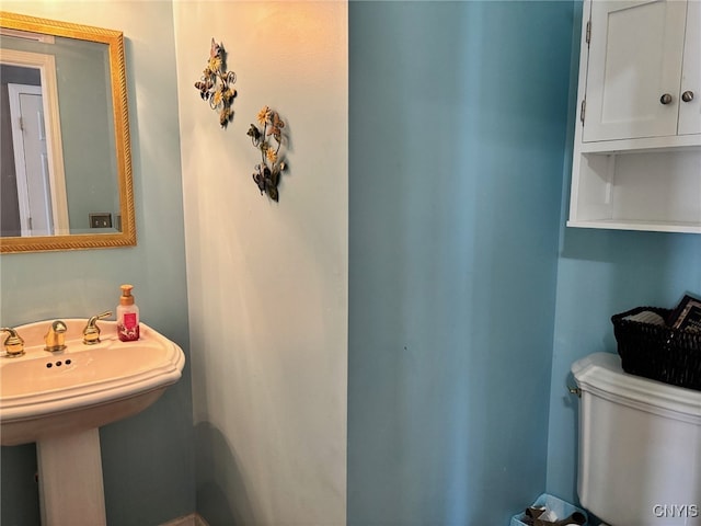 bathroom featuring toilet and a sink