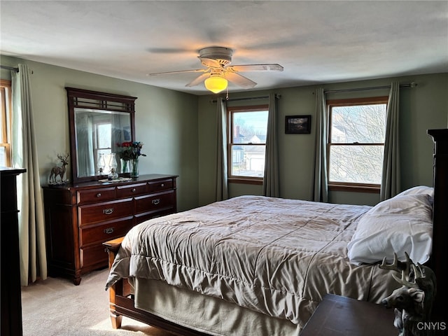 bedroom featuring light carpet and ceiling fan