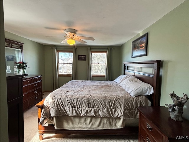 bedroom featuring light colored carpet and ceiling fan