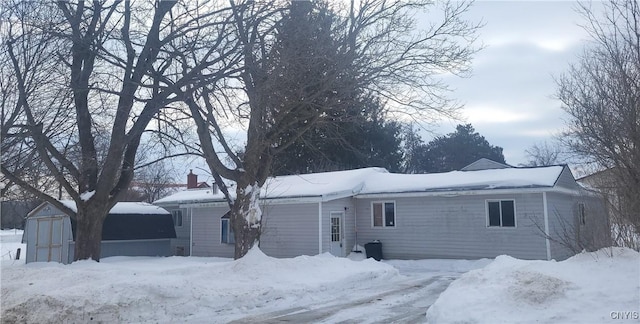 view of front of house featuring an outbuilding and a storage unit